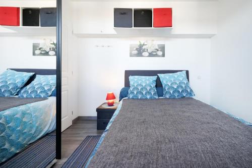 a bedroom with a mirror and a bed at Appartement Urrugne in Urrugne