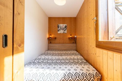 a small room with a bed in the corner at victorsun2 in La Clusaz
