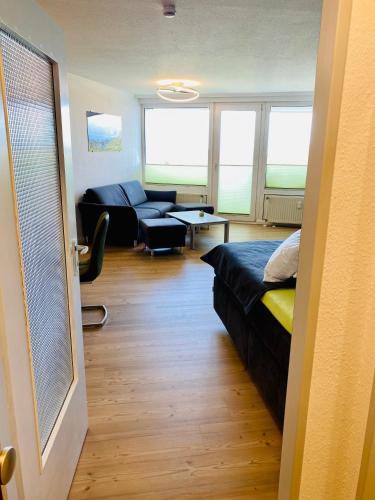 a room with a bed and a living room with a couch at 307 im Lord Nelson in Cuxhaven