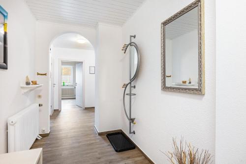 a bathroom with a shower and a mirror on the wall at Ferienwohnung Landblick in Homberg
