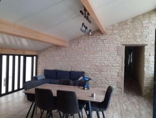 a living room with a blue couch and a table at Domaine du Val Bruant in Arc-en-Barrois