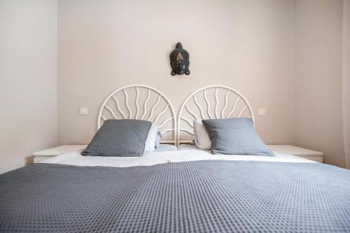 a bedroom with a large bed with two pillows at Casa Weimar in Costa Calma