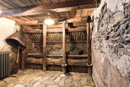 a kitchen in an old building with a stone wall at Tannhäuser Mountain Chalet in Predoi