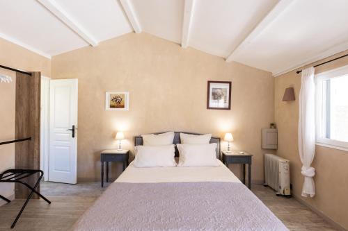 a bedroom with a large bed and two tables at Santa Maria in Manso