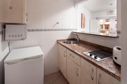 a small kitchen with a sink and a counter top at Estudio Bloque 90 in Torrox