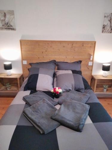 a bed with a bunch of pillows on it at Au Nid Douillet in Bourges
