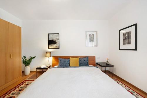 a bedroom with a large white bed with blue pillows at Kati´s Haus in San Pancrazio dʼUltimo