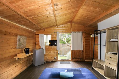 a room with wooden walls and a wooden ceiling at Le Chalet De La Plage in Coti-Chiavari