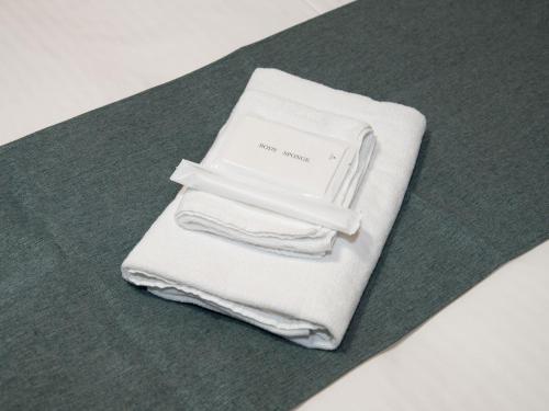 a pile of white towels sitting on a table at 小豆島宿いたち in Tonosho