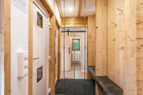 a hallway of a house with wooden walls at Alpenchalet zum Hirsch in Aschau