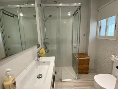 a bathroom with a shower and a sink and a toilet at Montiro in L'Escala