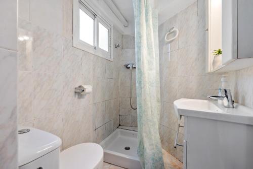 a bathroom with a toilet and a sink and a shower at Loft Jb in L'Ametlla de Mar