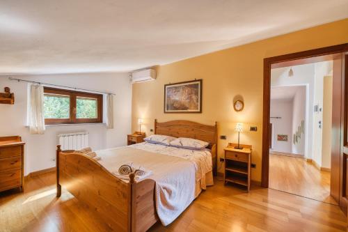 a bedroom with a large bed and a wooden floor at Villa Del Riccio in Magione
