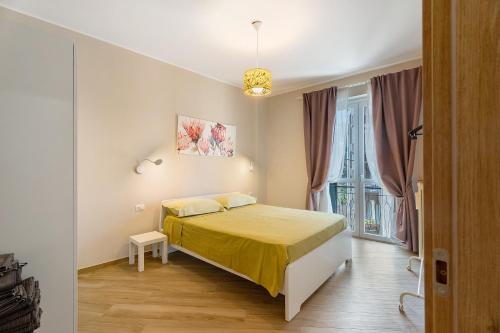 a bedroom with a bed with a yellow blanket at Casa Làrisa Lago Maggiore in Laveno-Mombello