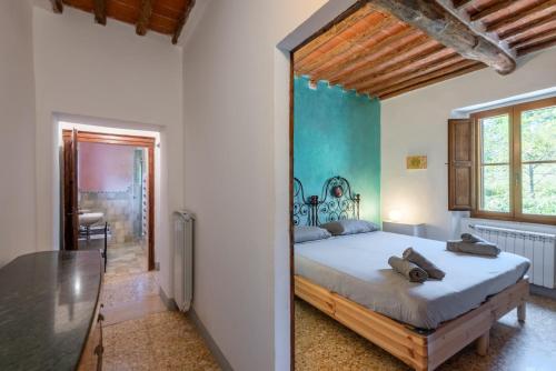 a bedroom with a large bed and a table at Podere La Speranza in Chiusdino