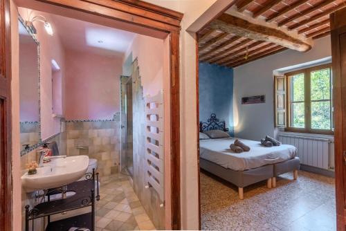 a bedroom with a bed and a shower and a sink at Podere La Speranza in Chiusdino