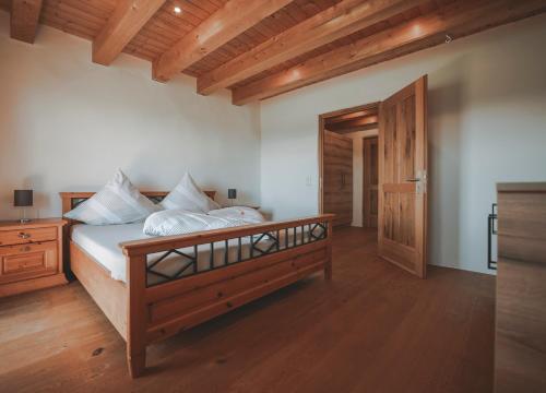 a bedroom with a large bed with a wooden frame at Ferienhaus Kaiser in Aßling