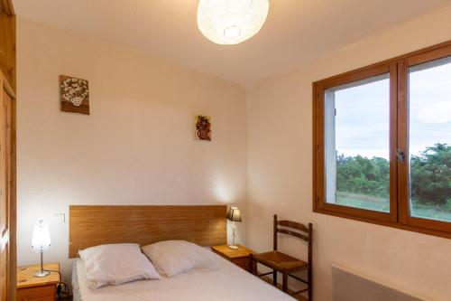 a bedroom with a bed and a window at Les Sources Gîte Sauvignon in Chambonas