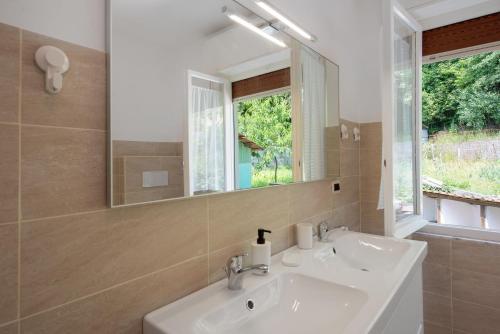 a bathroom with a white sink and a mirror at Villino Chiara in Pannesi