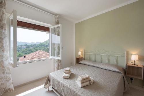 a bedroom with a bed and a large window at Villino Chiara in Pannesi