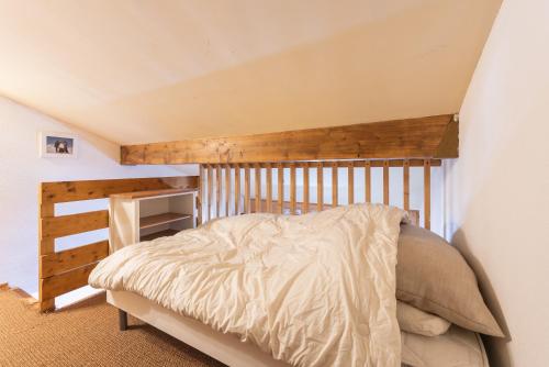 a bedroom with a bed with a wooden headboard at Appartement 6 pers Piau Engaly in Aragnouet