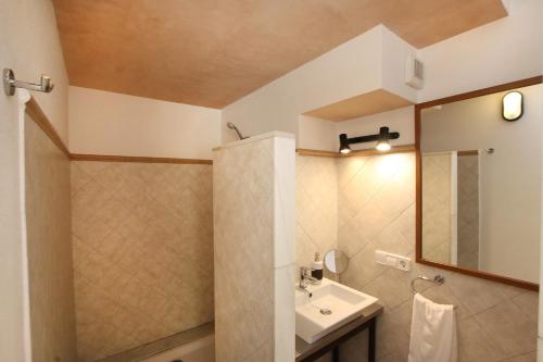 a bathroom with a sink and a mirror at Ca Na Barbara in Santanyi