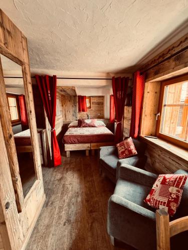 a bedroom with a bed and a couch in a room at Chalet du Paradis in Cogne