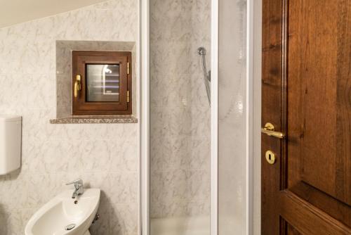 a bathroom with a sink and a toilet and a mirror at Papà Giuseppe Il Fienile in Cortona