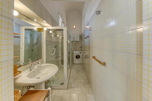 a bathroom with a sink and a shower at Luisa in Leuca
