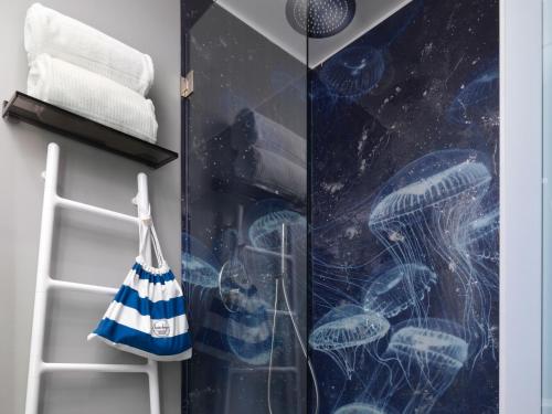 a bathroom with a shower with a glass door at Anjoy&Bleev Rooms in Rho