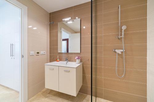 a bathroom with a sink and a shower at Casa Delfin in Moraira