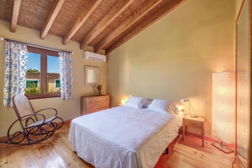 a bedroom with a white bed and a window at Can Om in Campos