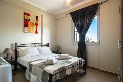 a bedroom with a bed and a window at Zoi apartment in Kefallonia