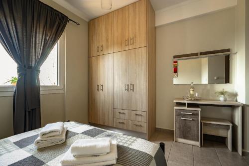 a bedroom with a bed and a sink and a mirror at Zoi apartment in Kefallonia
