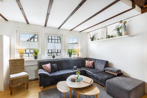 a living room with a couch and a table at Ferienhaus Weitblick in Eslohe
