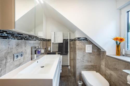 a bathroom with a white tub and a sink at Ferienwohnung Familie Süttner in Nagel