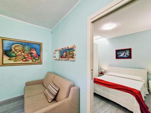 a bedroom with a bed and a couch in a room at Villa Galatea La Conchiglia in Capoliveri