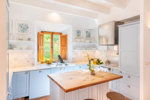 a kitchen with blue cabinets and a wooden counter top at Casa Amber in Sóller