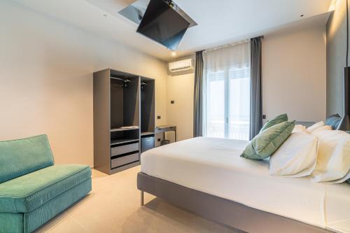 a bedroom with a large bed and a couch at Bellini House in Viagrande