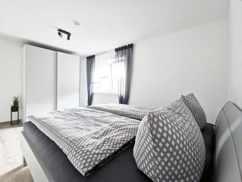a bedroom with two beds and a window at Rehkitz in Baiersbronn