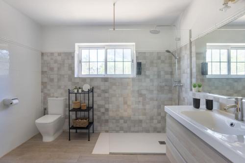 a bathroom with a sink and a toilet and a tub at Casa Can Mussenya in Illes Balears