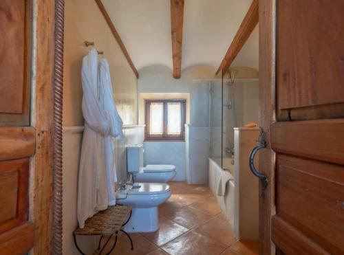 a bathroom with a sink and a toilet and a shower at Sa Cala in Deia