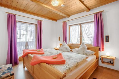 a bedroom with two beds and purple curtains at Ferienwohnung König im Obergeschoss in Berchtesgaden
