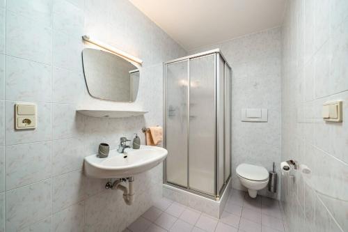 a bathroom with a sink and a shower and a toilet at Eggerhof Familienparadies in Verano