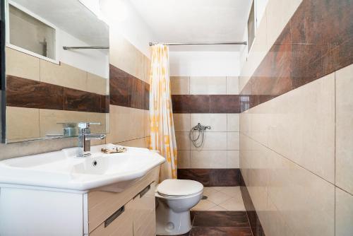 a bathroom with a sink and a toilet at Panorama Tilos Apt B in Tílos