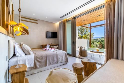 a bedroom with a bed and a large window at Studio Yvonne in Meganisi