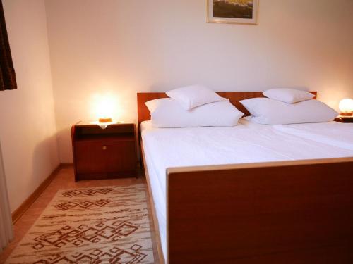 a bedroom with a bed with white sheets and pillows at Börsighof in Seebach