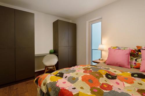 a bedroom with a bed and a chair and a window at Wohnung 4 Rosenstraße in Cham