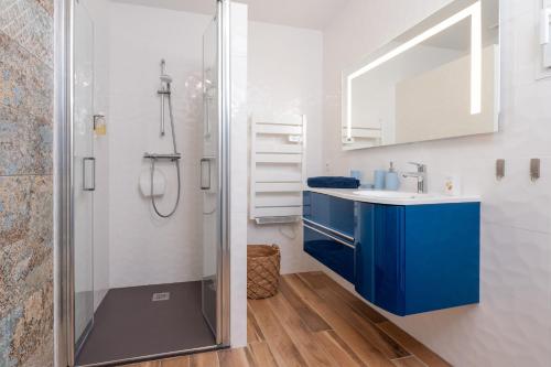 a bathroom with a blue sink and a shower at Ty Laouen Gite Quiberon in Quiberon