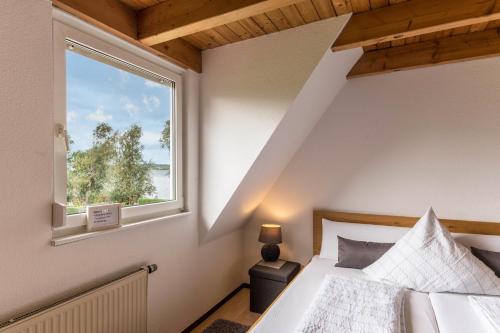 a bedroom with a bed and a window at Appartement Böhler 2 in Reichenau
